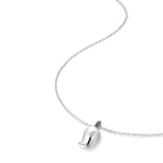 Silver mango pendant necklace shown at angle displaying curved chain and sculptural pendant placement