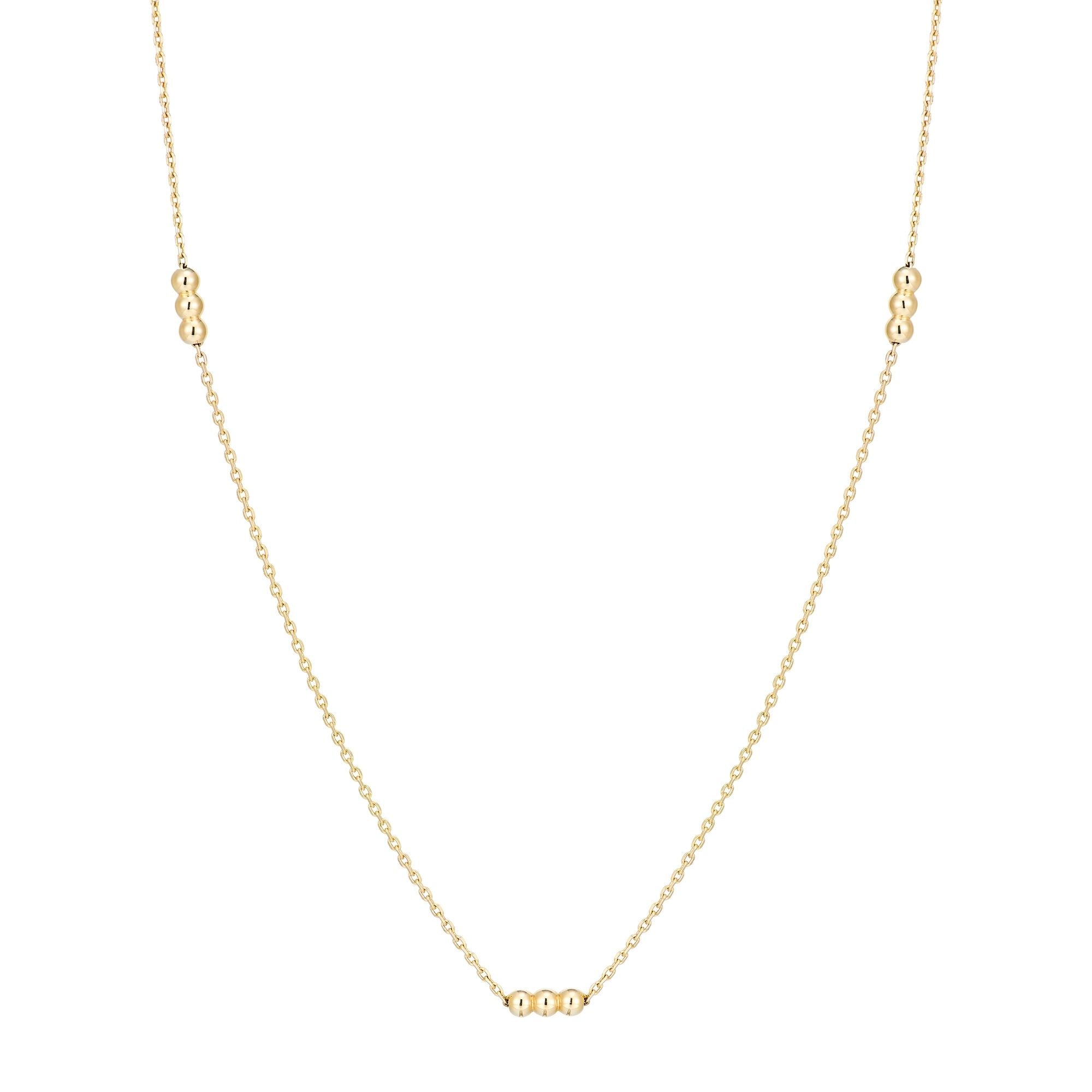 Inessa gold bead trio necklace displayed flat, showing complete 14k reclaimed gold design