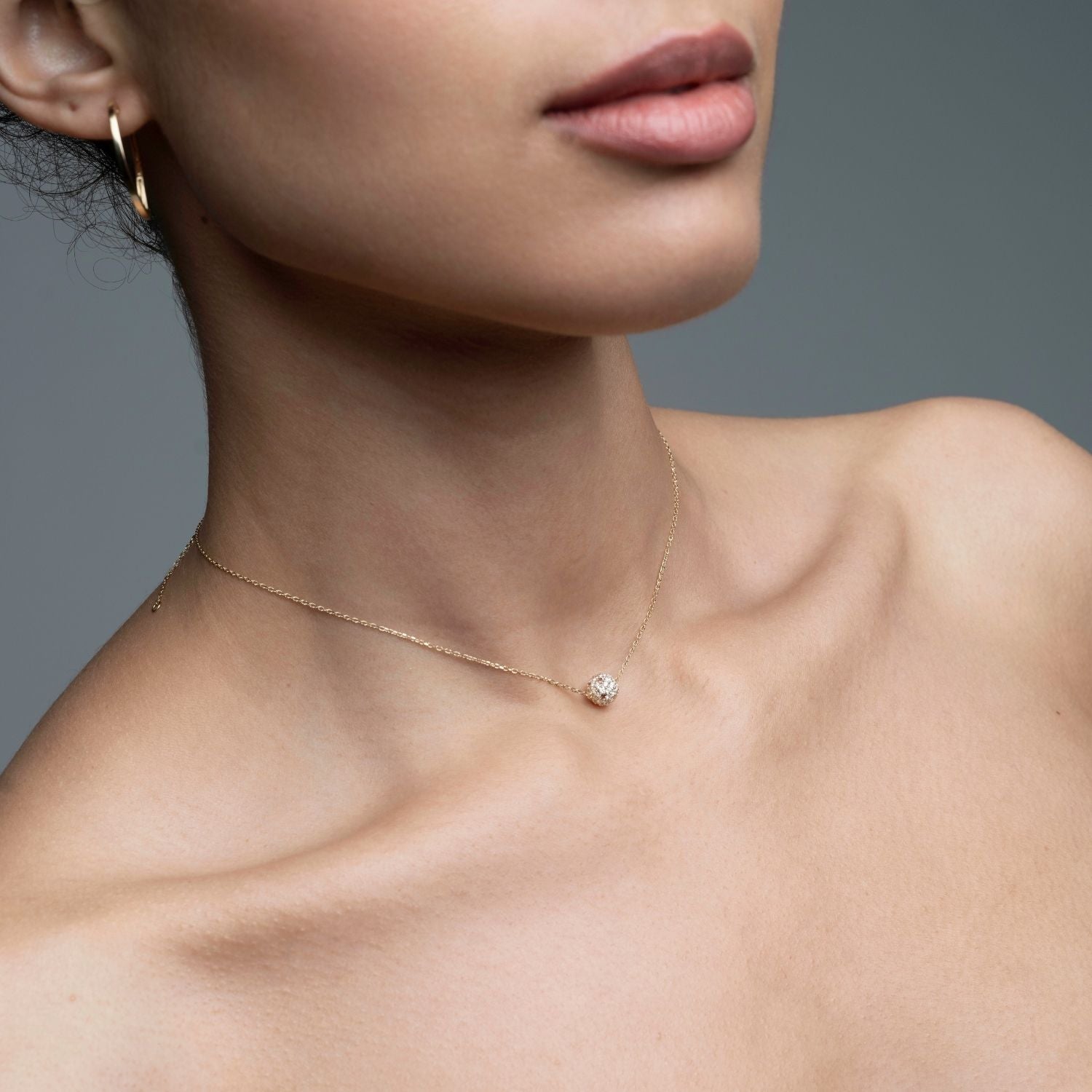 Inessa lotus ball diamond tourmaline necklace worn by model, 14k gold from Strength Collection