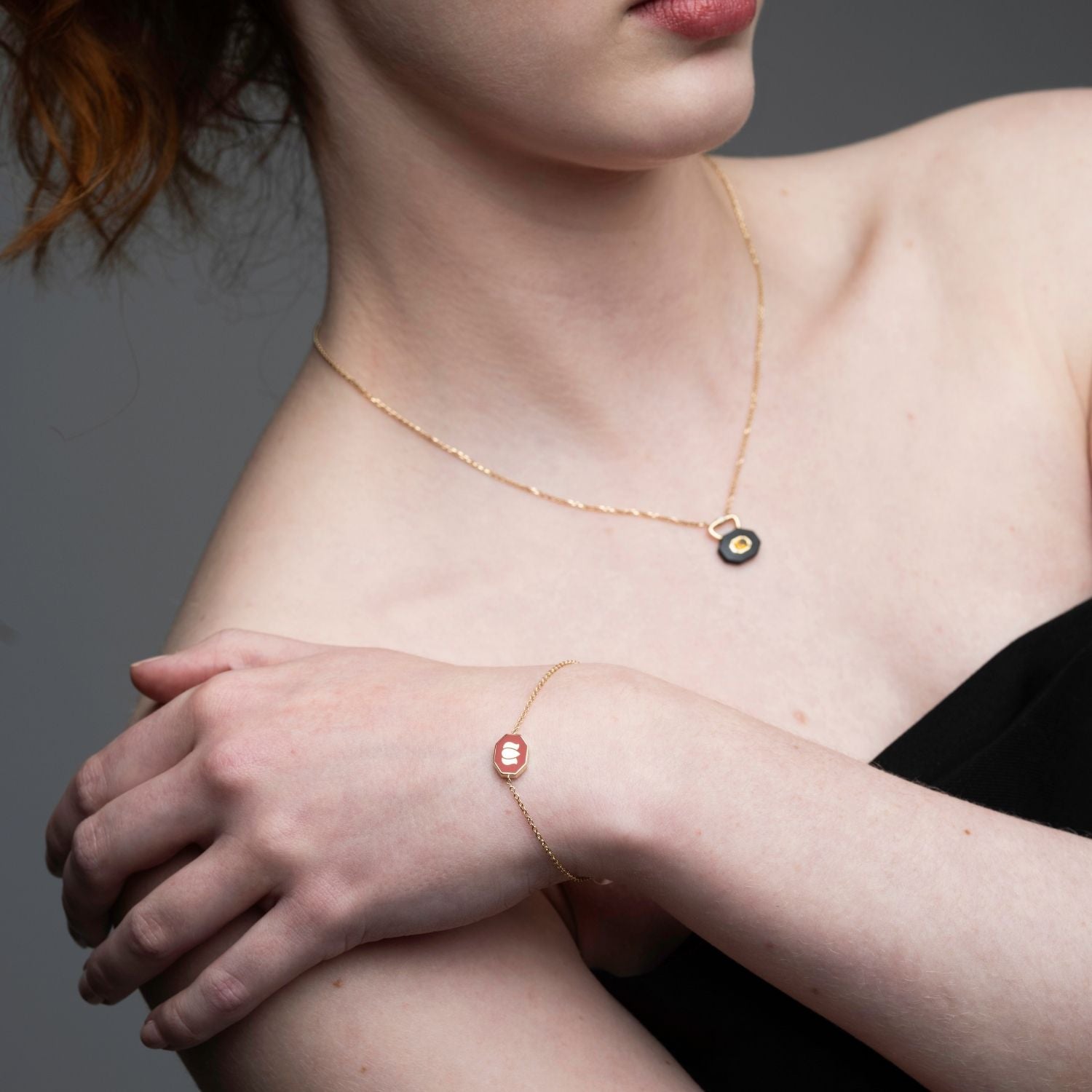 Inessa lotus maroon ceramic bracelet worn with coordinating necklace, 14k gold Strength Collection