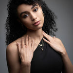 Woman wearing mango diamond necklace layered with gold chains from Inessa Love Collection