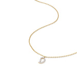 Delicate gold mango pendant with sparkling diamond outline shown on curved chain for scale reference