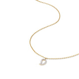 Delicate gold mango pendant with sparkling diamond outline shown on curved chain for scale reference