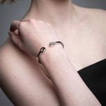 Close-up of mango silver bracelets in recycled sterling silver showing organic sculptural shape