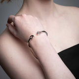 Close-up of mango silver bracelets in recycled sterling silver showing organic sculptural shape