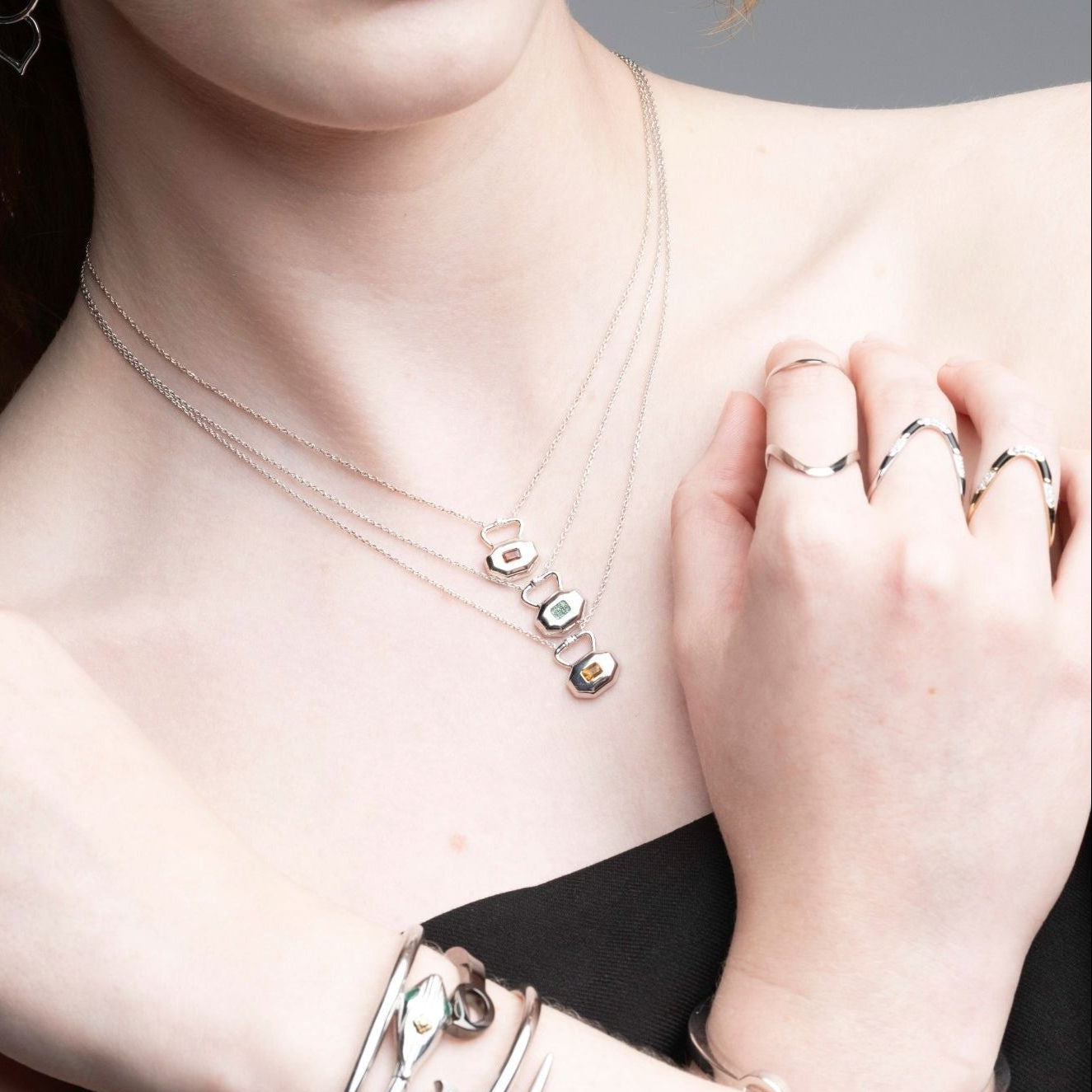 Comprehensive styling of Inessa Milestones Collection featuring birthstone locks, rings, and bracelets in layered look
