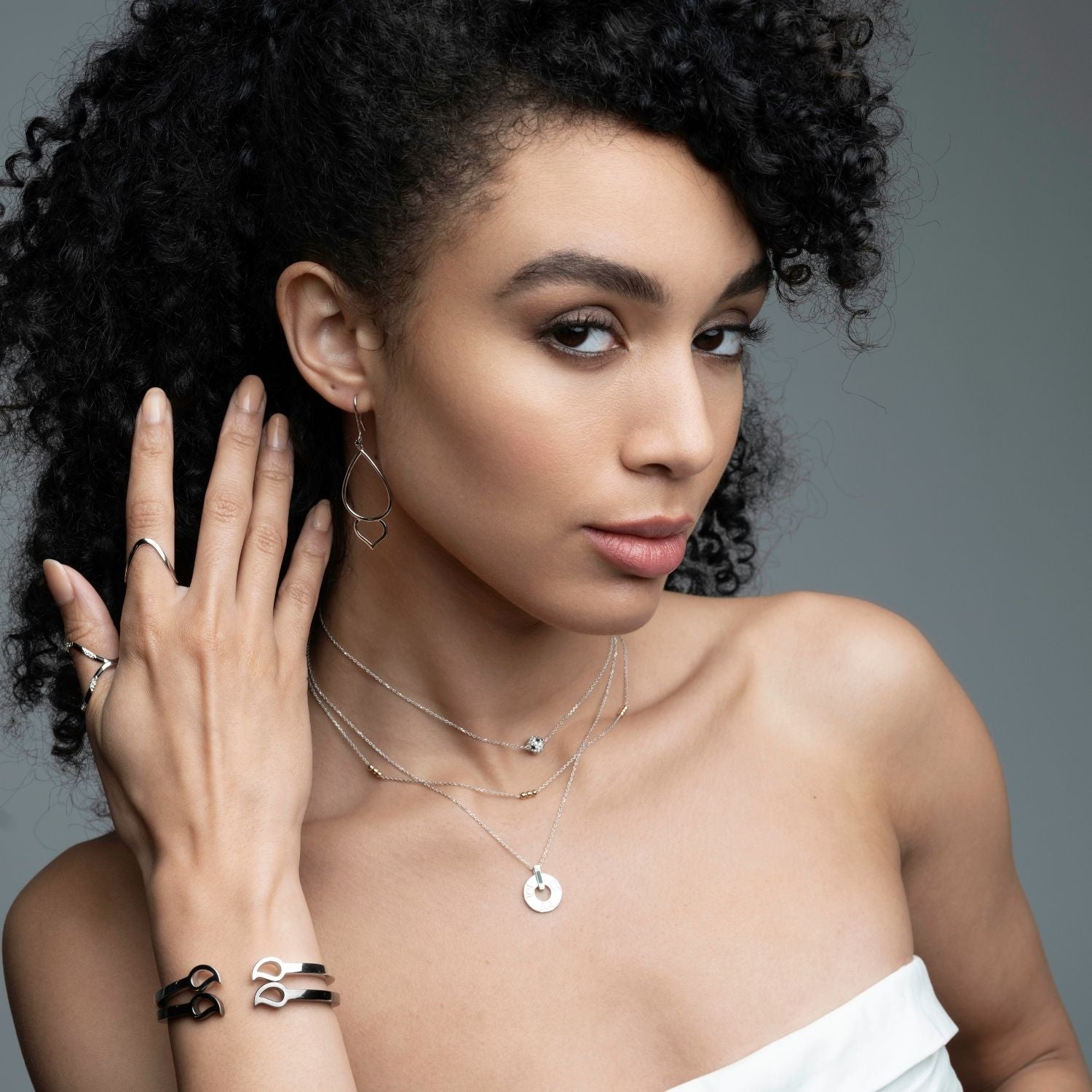 Woman wearing mixed metal trio layering necklace with gold beads and silver chain from Stackable Collection