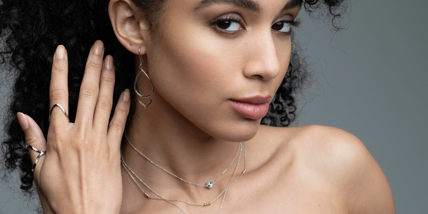 Woman wearing mixed metal trio layering necklace with gold beads and silver chain from Stackable Collection