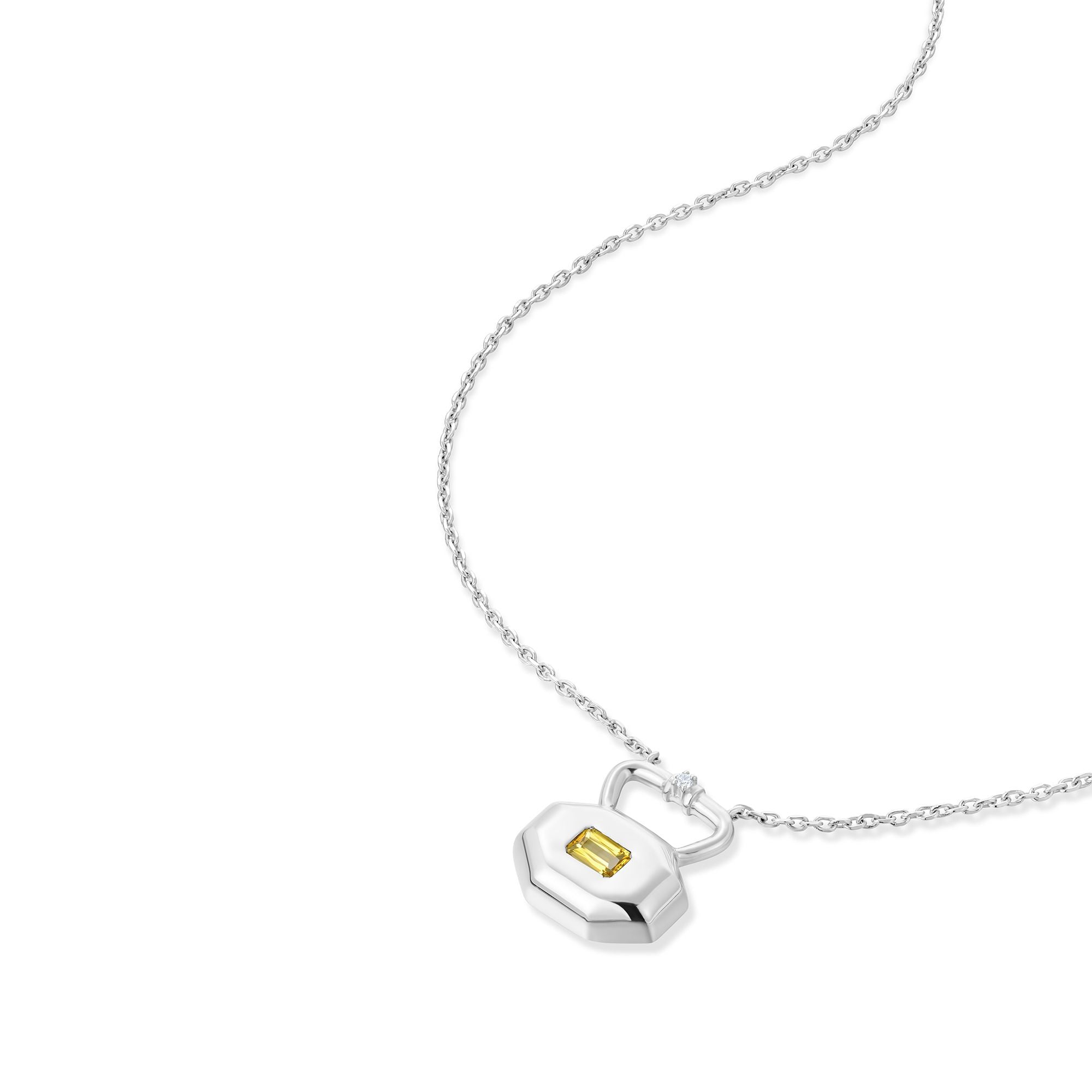 November citrine birthstone lock pendant shown at angle displaying natural movement and light reflection on silver chain