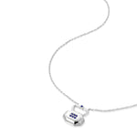 September blue sapphire birthstone lock pendant shown at angle displaying natural movement and light reflection on silver chain