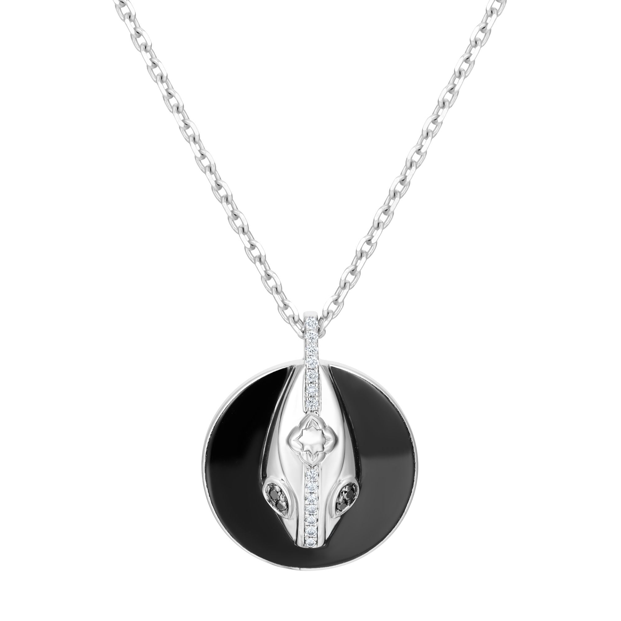 Close-up of serpent pendant on black ceramic coin with sterling silver chain, meaningful transformation necklace