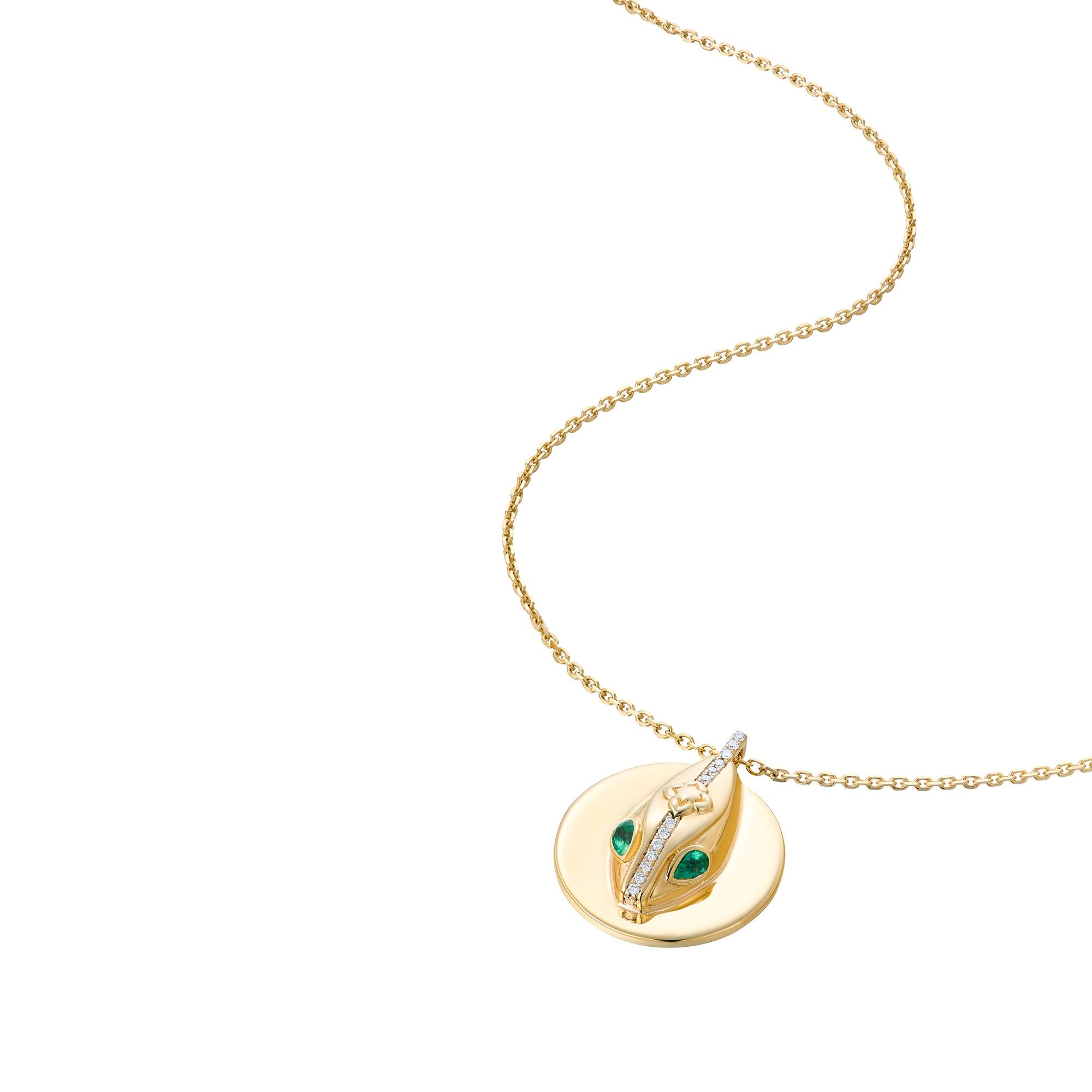Angled view of serpent coin pendant necklace showing dimensional design and natural chain drape