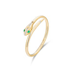 Side view of 14k gold serpent hinged bangle showing emerald eyes and diamond spine details, transformation jewelry