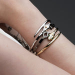 Stacked serpent hinged bangles in sterling silver and 14k gold from Inessa Renewal Collection