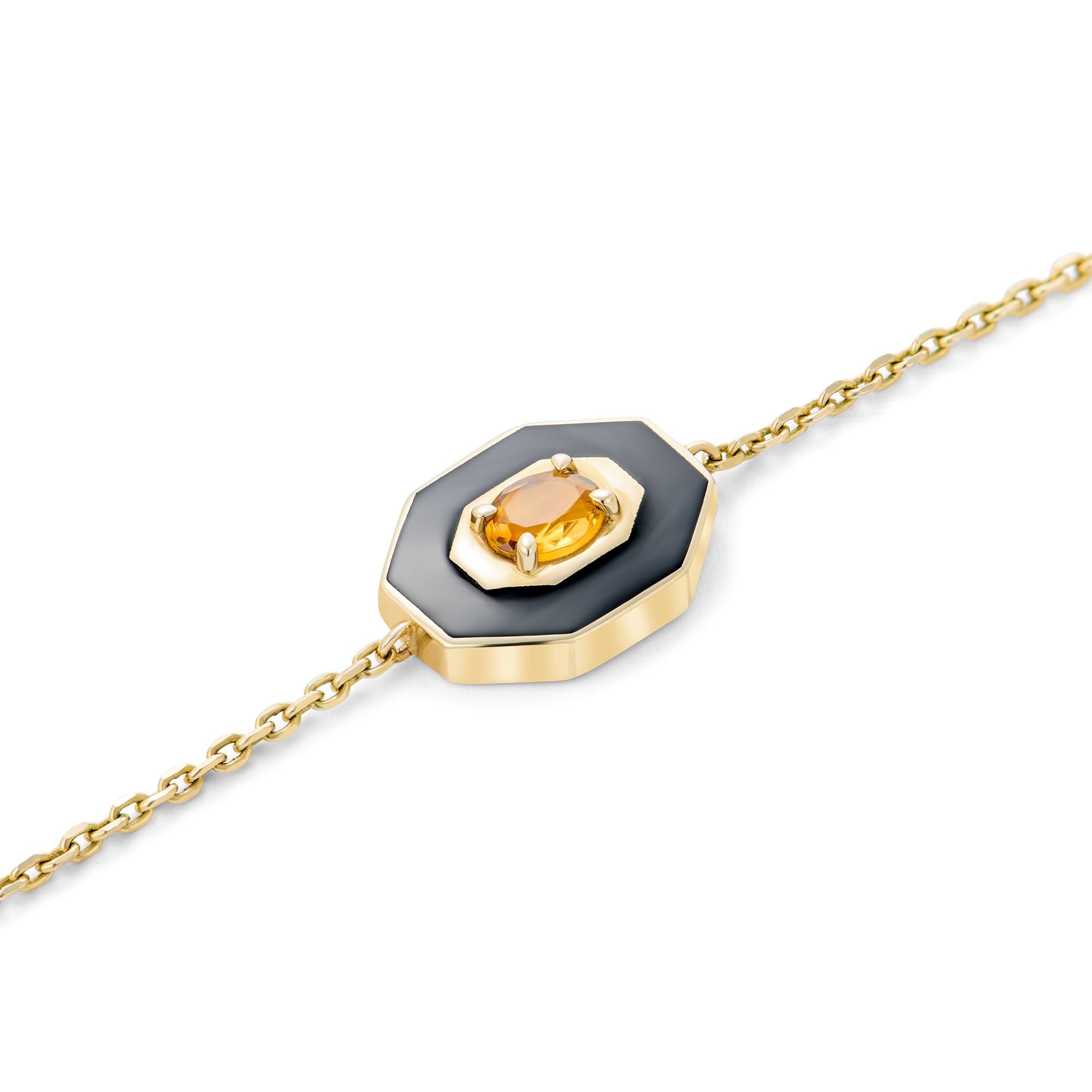 Black ceramic lotus charm with oval citrine gemstone in 14k gold setting, meaningful jewelry