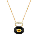 Gold necklace with a black ceramic pendant shaped like a lock featuring an oval citrine on a white background