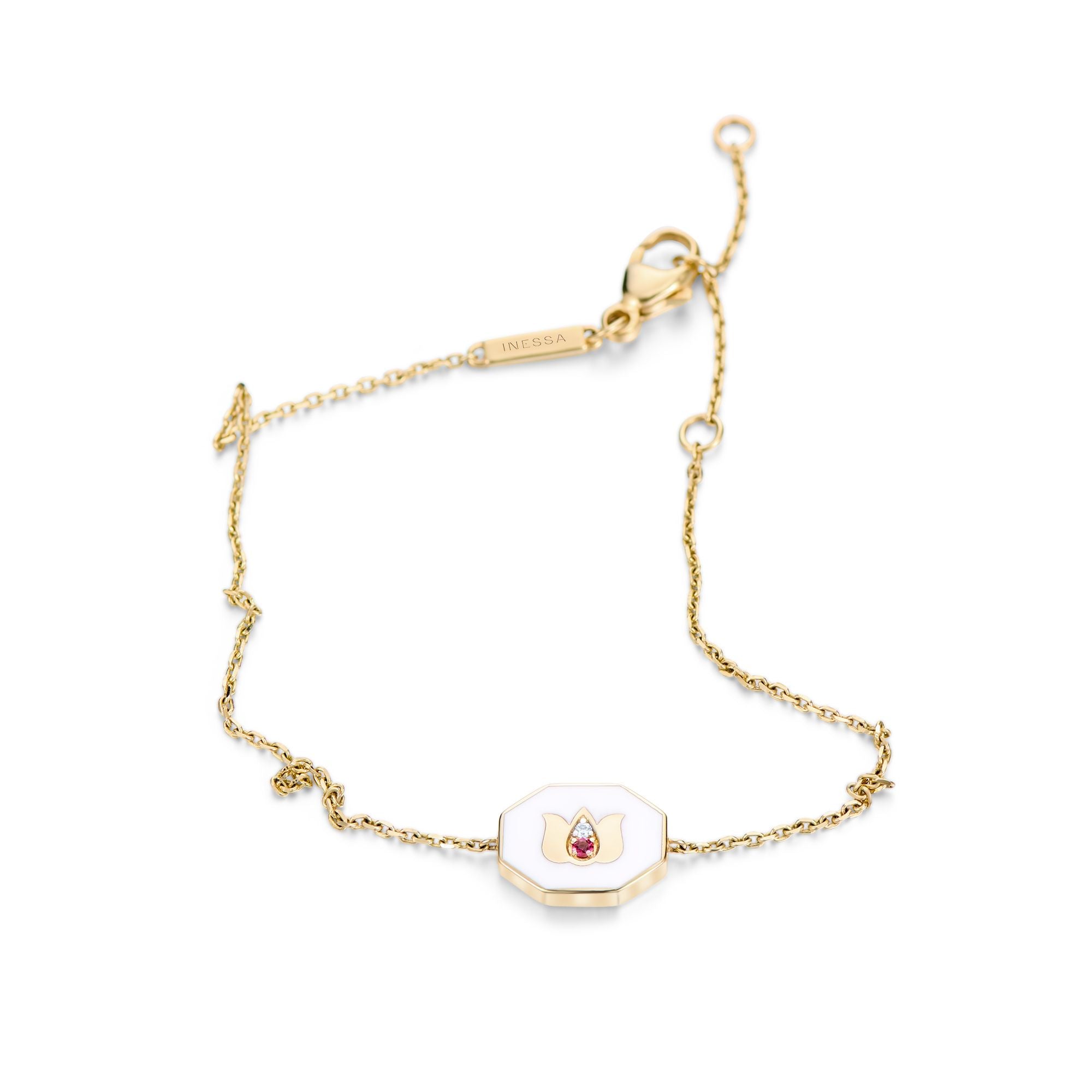 White ceramic lotus symbol bracelet with tourmaline accents arranged elegantly on white background