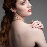  Woman wearing 14k gold wave ring with pink tourmaline and diamonds from Confidence Collection