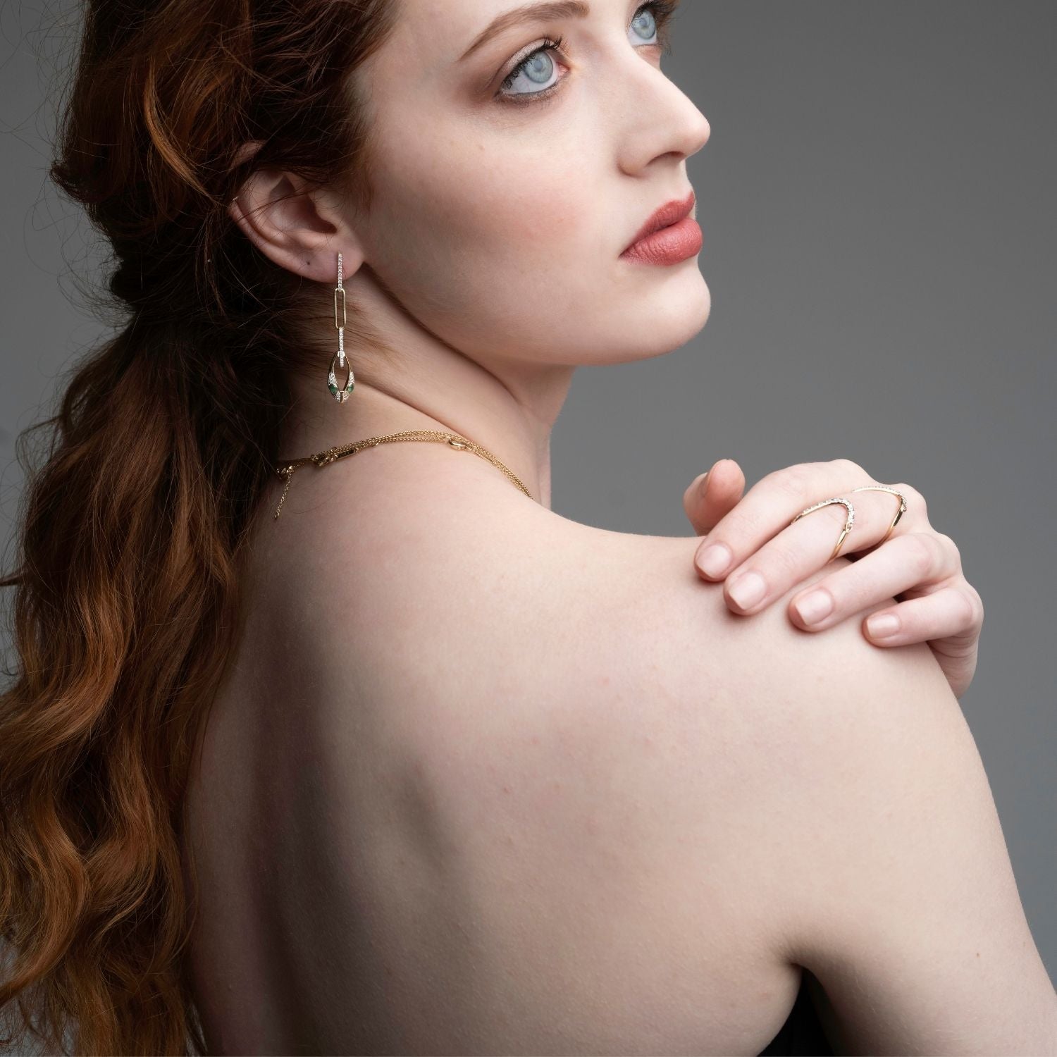  Woman wearing 14k gold wave ring with pink tourmaline and diamonds from Confidence Collection